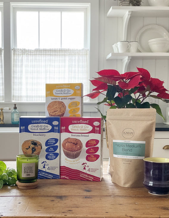 The packages of muffins on counter with bag of coffee and candle