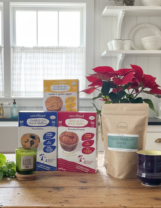 The packages of muffins on counter with bag of coffee and candle