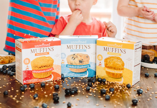 3 muffin boxes with kids behind enjoying breakfast